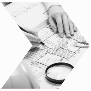 Hands drawing architectural blueprints